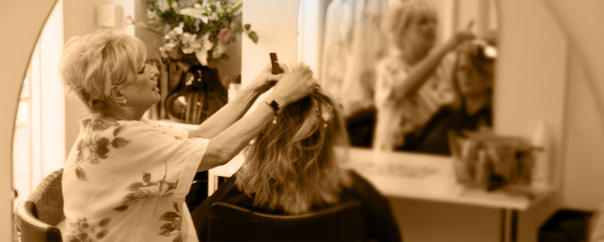 Image of Luna hair dresser in Bath. Lyn cutting a customers hair. Lyn hairdressing in Bath